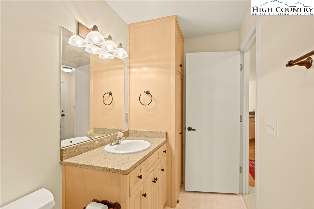 151 Deer Valley Drive, Unit 225 Boone, NC 28607 - Photo 25 of 31 a bathroom with a sink a mirror and a shower