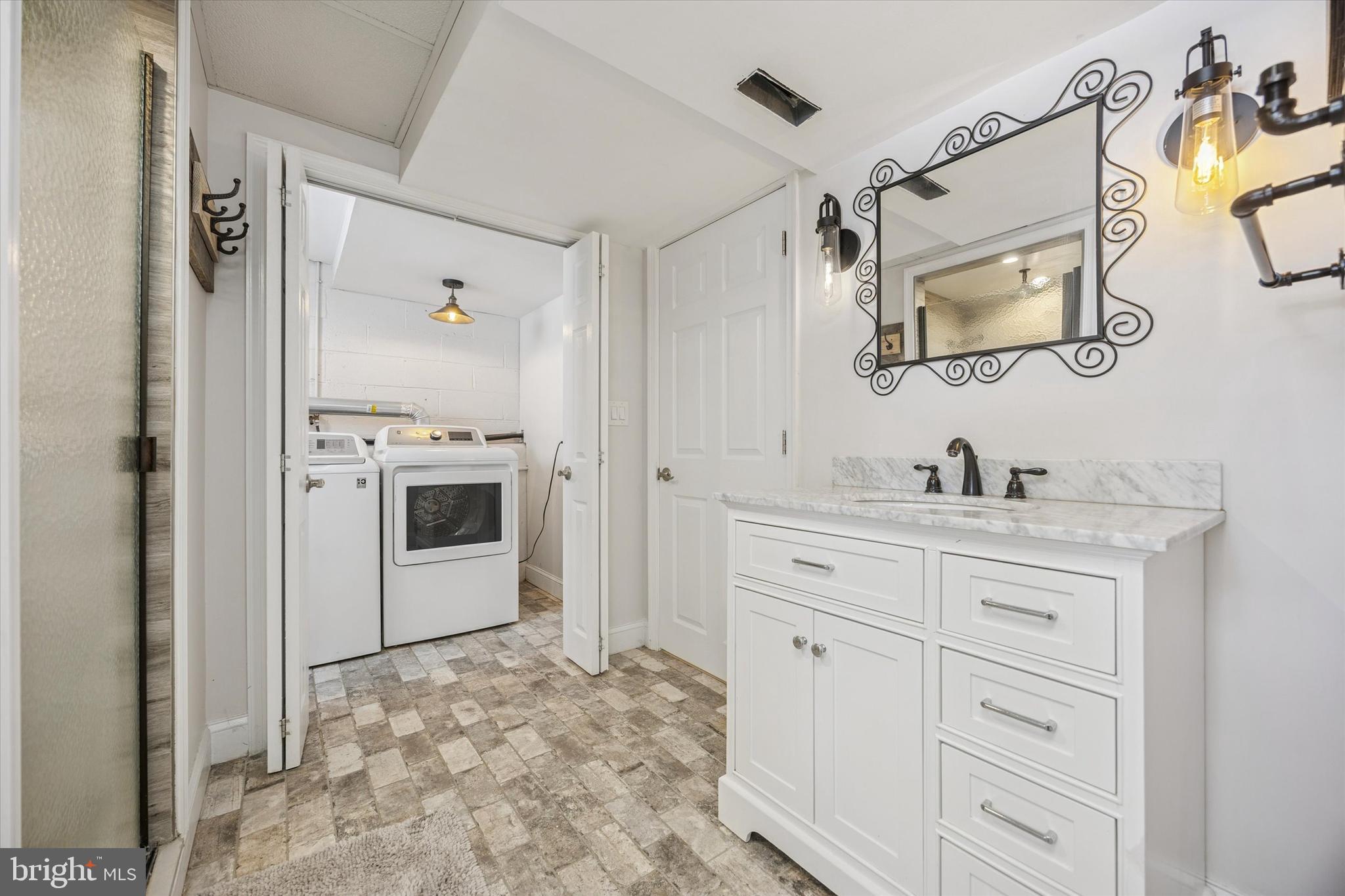 8516 Chippewa Road Philadelphia, PA 19128 - Photo 13 of 20 a spacious bathroom with a granite countertop sink a mirror a vanity and a shower