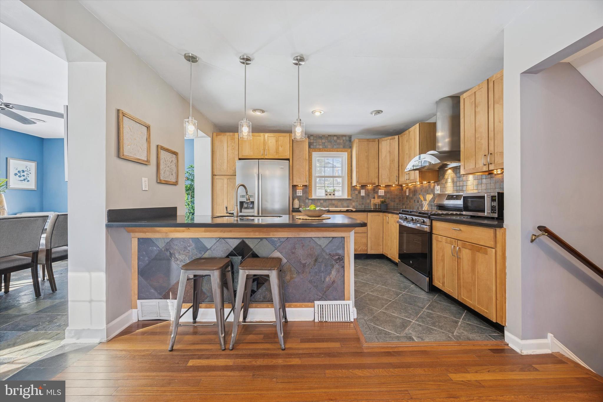 8516 Chippewa Road Philadelphia, PA 19128 - Photo 5 of 20 a kitchen with stainless steel appliances granite countertop wooden floors and white cabinets