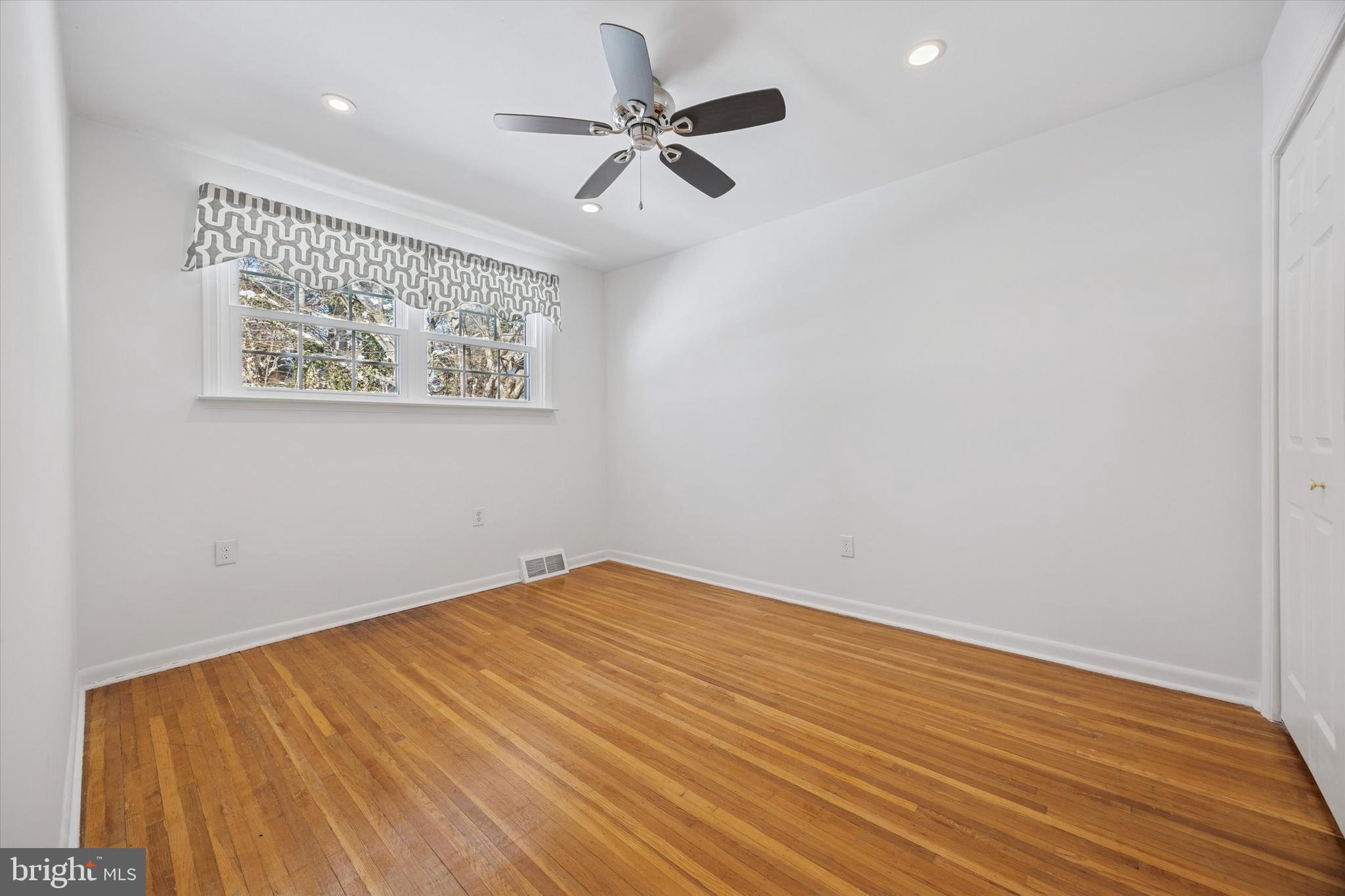 8516 Chippewa Road Philadelphia, PA 19128 - Photo 10 of 20 an empty room with a ceiling fan and wooden floor