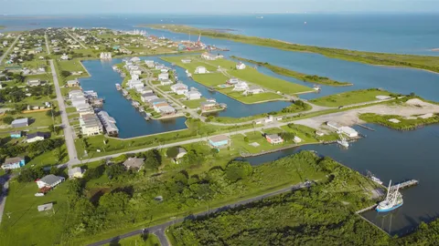 an aerial view of a residential houses with outdoor space and river