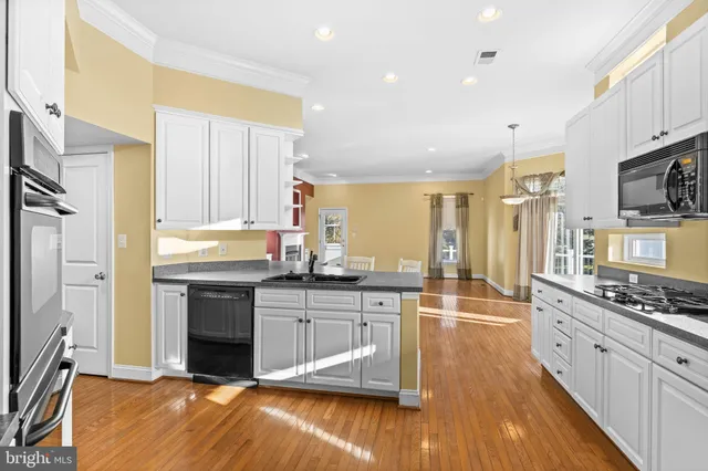 a kitchen with stainless steel appliances a stove sink and cabinets