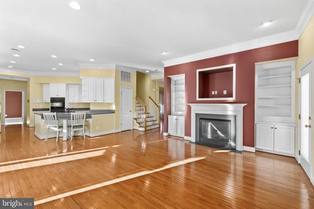 a living room with furniture a fireplace and kitchen view