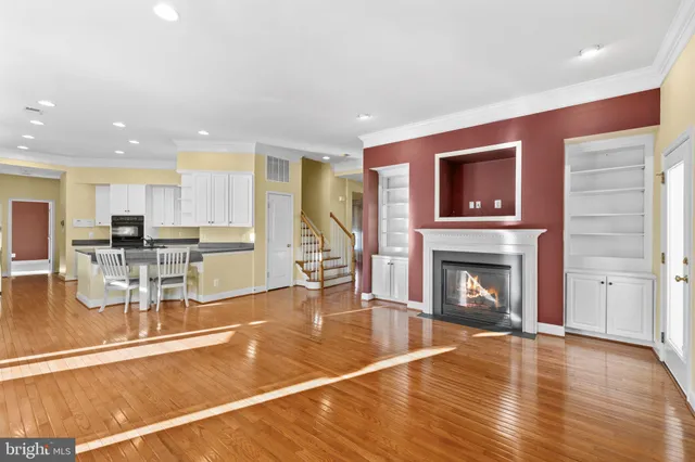 a living room with furniture a fireplace and kitchen view