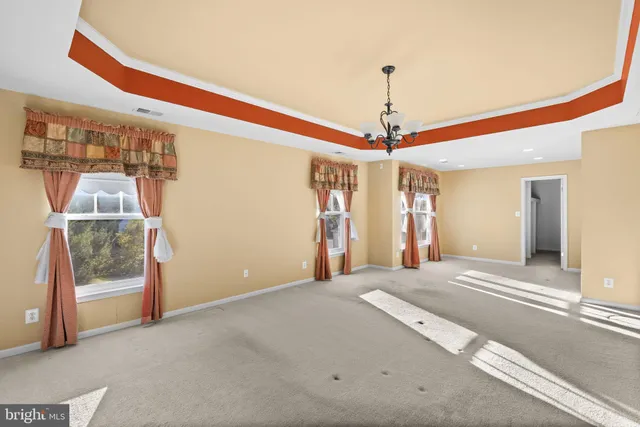 a view of a hallway with a chandelier