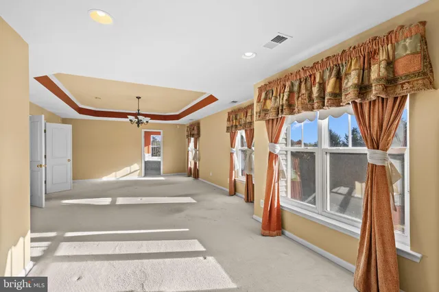 a bathroom with a granite countertop sink and a bathtub