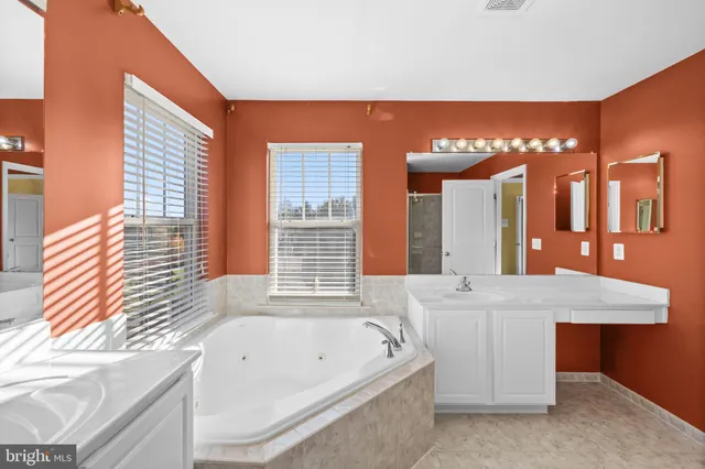 a view of a room with wooden floor and windows