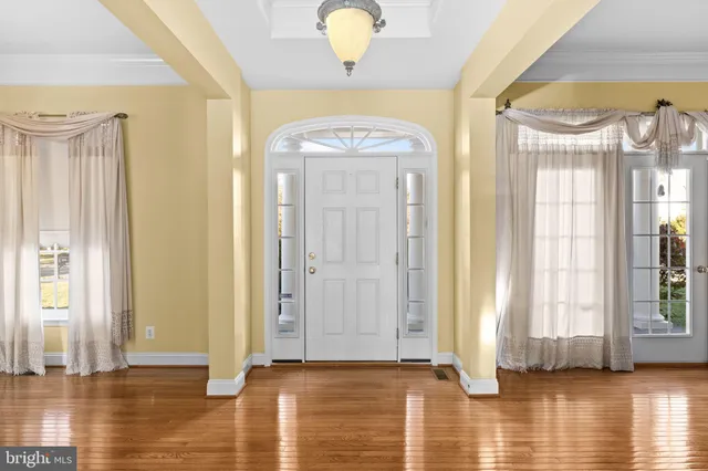 a view of an entryway with wooden floor