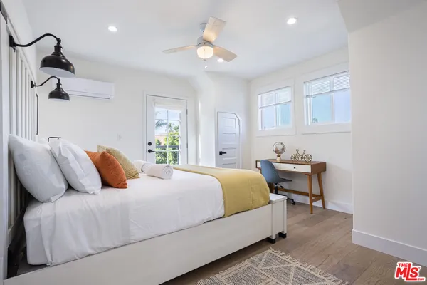 a bedroom with bed and a potted plant