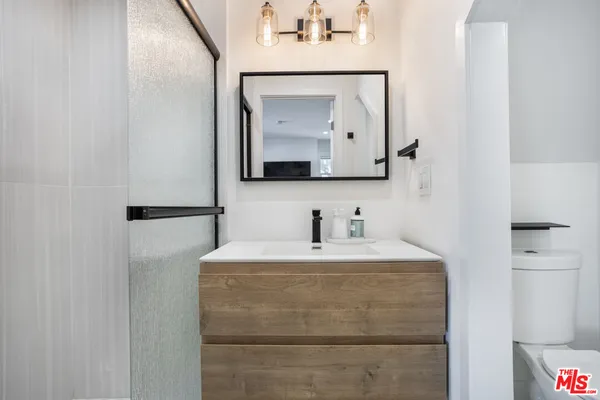 a bathroom with a sink vanity and a mirror