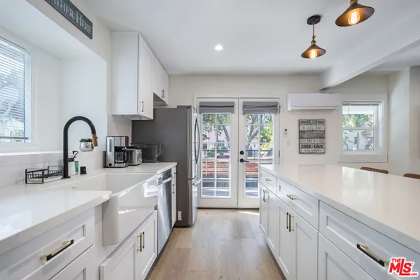 a kitchen with counter top space a sink cabinets and appliances