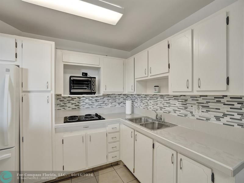 a kitchen with stainless steel appliances white cabinets and a stove