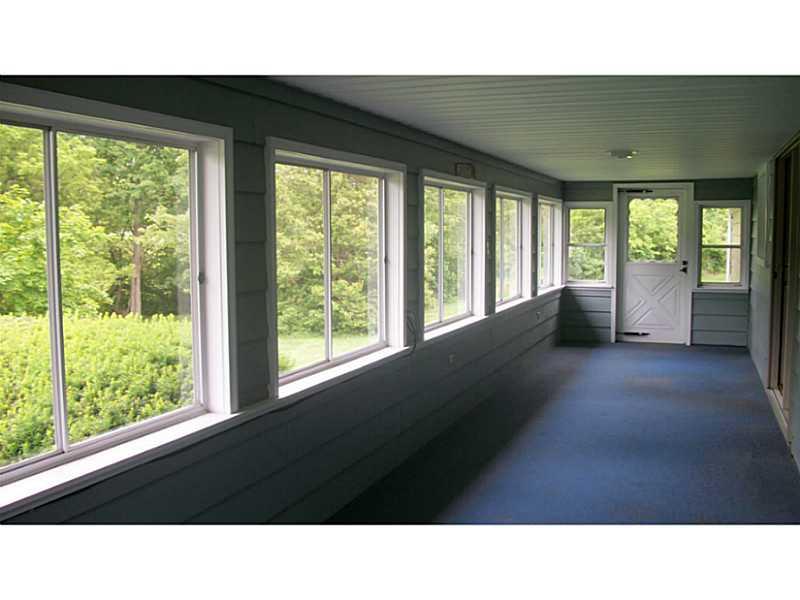 741 White City Road Ligonier, PA 15658 - Photo 17 of 23 Sunroom. This enclosed porch spans the entire width of the back of the house.