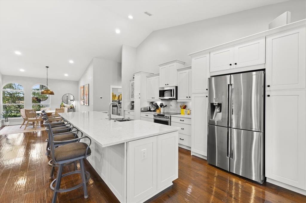 10349 Camelback Lane Boca Raton, FL 33498 - Photo 11 of 38 a kitchen with sink cabinets and stainless steel appliances