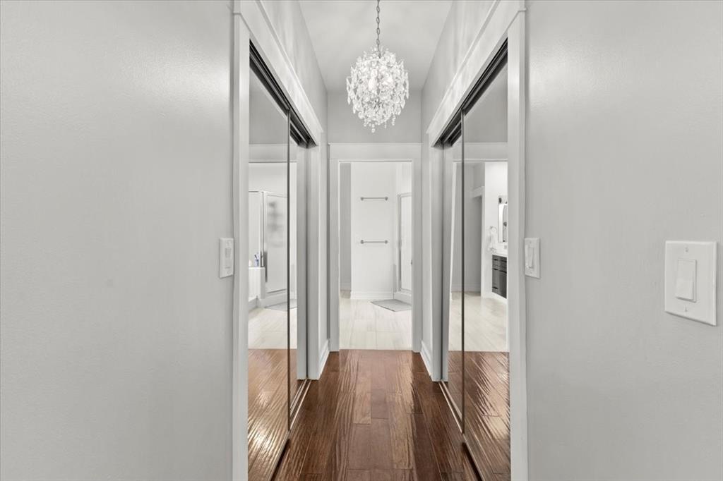 10349 Camelback Lane Boca Raton, FL 33498 - Photo 18 of 38 a view of a hallway with wooden floor and chandelier