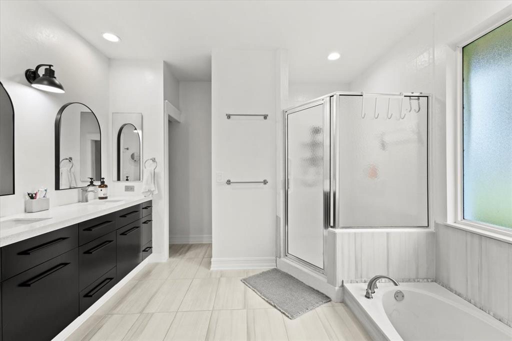 10349 Camelback Lane Boca Raton, FL 33498 - Photo 20 of 38 a spacious bathroom with a double vanity sink a mirror and a bathtub