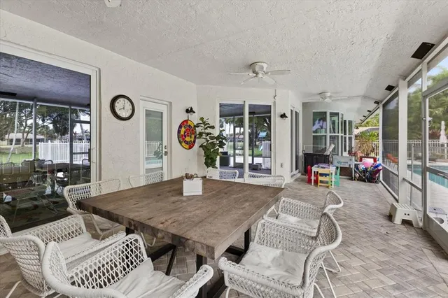 a view of a dining room with furniture and a large window
