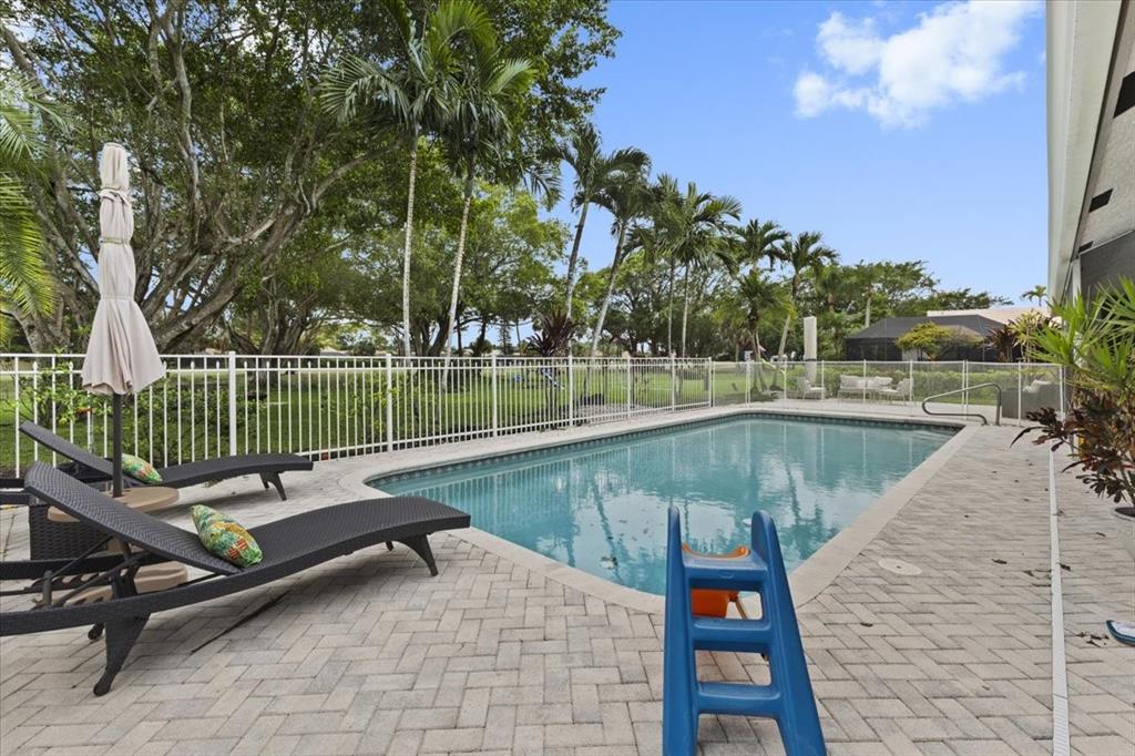 10349 Camelback Lane Boca Raton, FL 33498 - Photo 32 of 38 a view of a swimming pool with a patio and a yard
