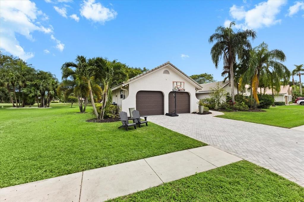 10349 Camelback Lane Boca Raton, FL 33498 - Photo 4 of 38 a front view of a house with yard and green space