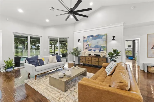 a living room with furniture fireplace and a large window