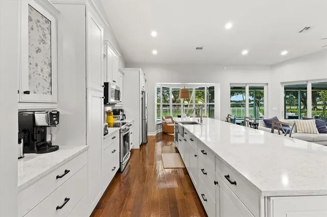 a kitchen with sink cabinets and stainless steel appliances