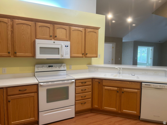 2043 Abbey View Road West Jordan, UT 84088 - Photo 4 of 15 Kitchen featuring light wood cabinetry, white countertops, white range, white microwave, and white dishwasher