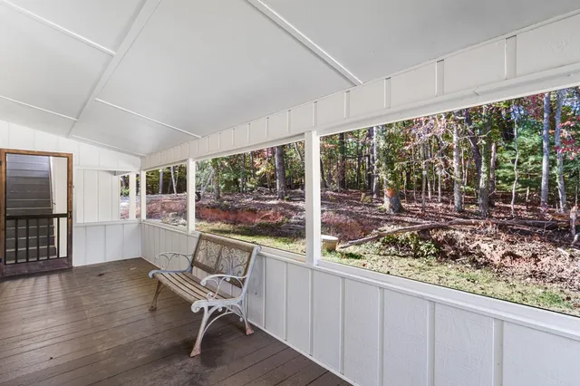 a view of a room with wooden floor and furniture