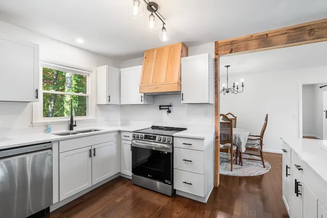 a kitchen with a stove a sink and a refrigerator