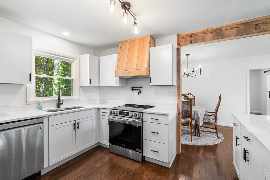 128 Cardinal Lane Hayesville, NC 28904 - Photo 20 of 40 a kitchen with a stove a sink and a refrigerator