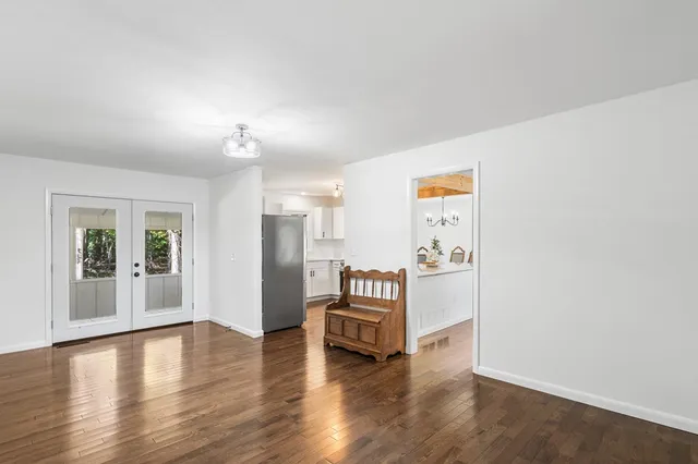 a view of a room with wooden floor and window