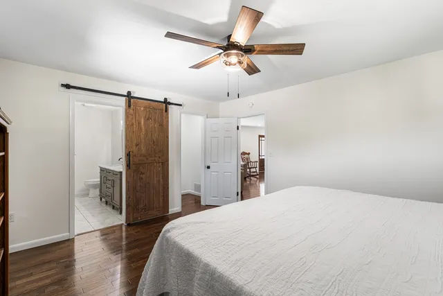 a bedroom with a bed and a ceiling fan