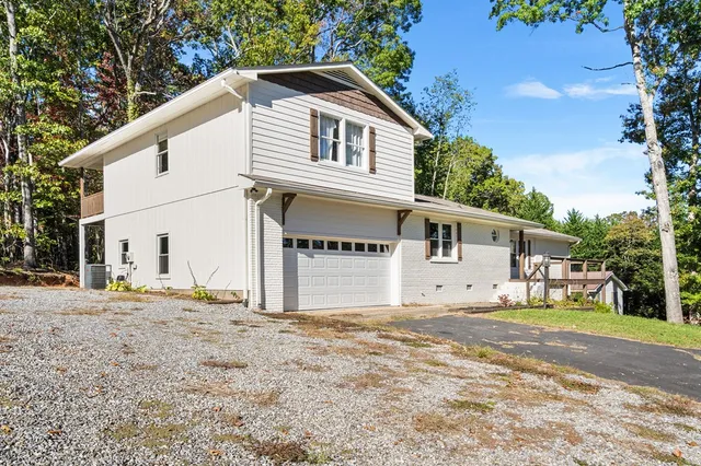 a house that has a tree in front of it