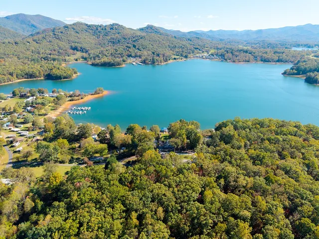 an aerial view of a houses with a lake view