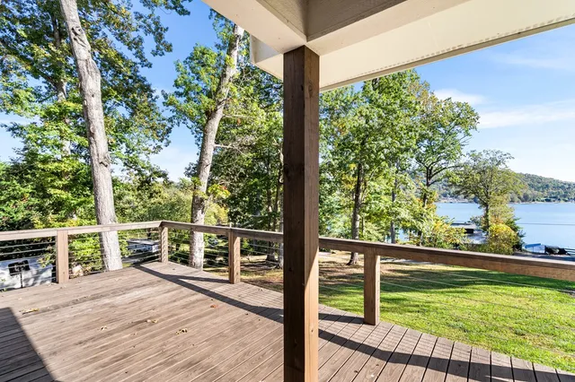a view of a balcony with lake view and wooden floor