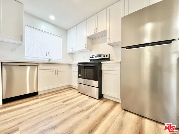 a kitchen with stainless steel appliances a refrigerator and a sink