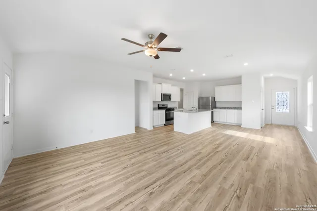 a view of a kitchen with a sink and wooden floor