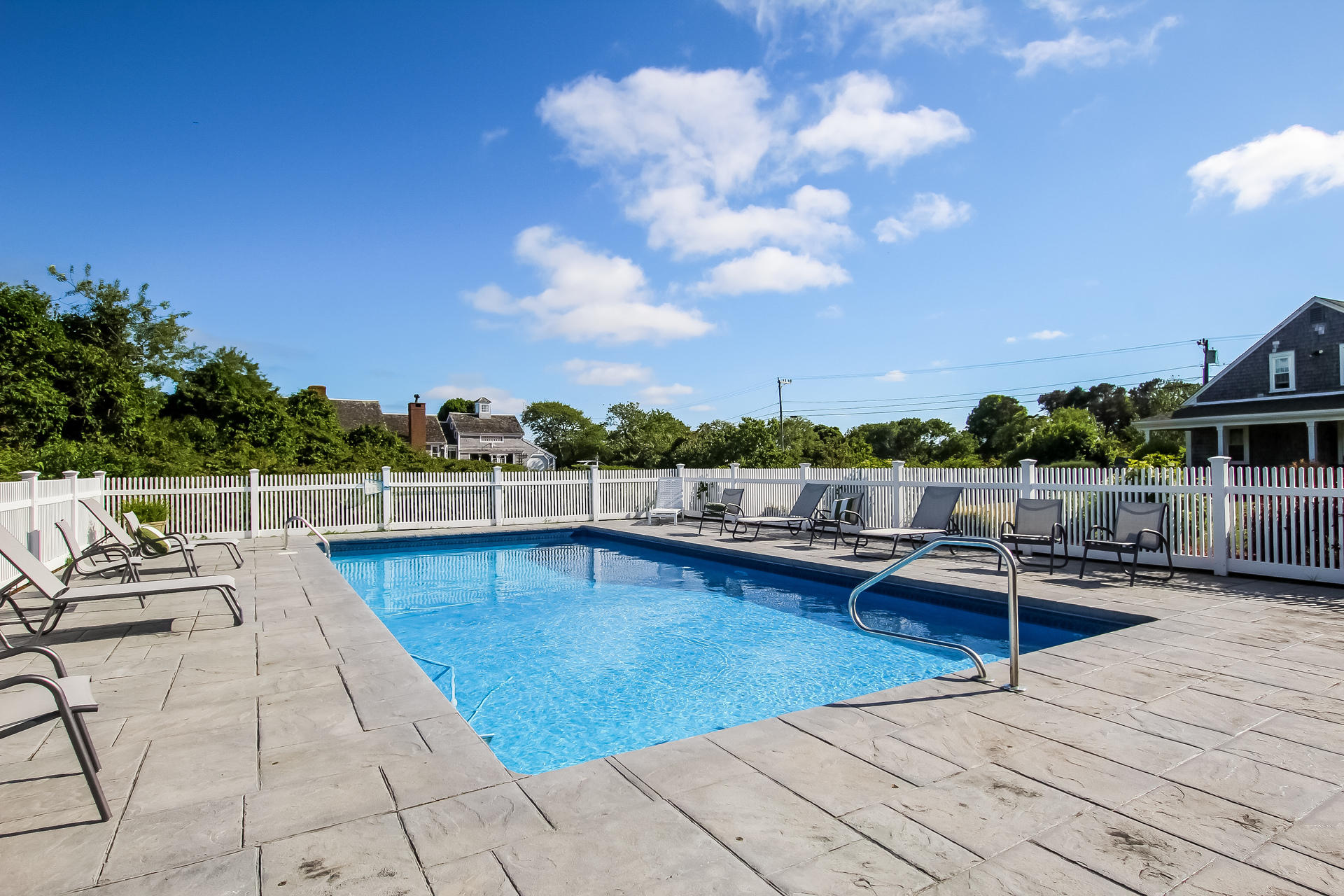 489 Stage Harbor Road Chatham, MA 02633 - Photo 27 of 34 a view of a swimming pool with lounge chairs
