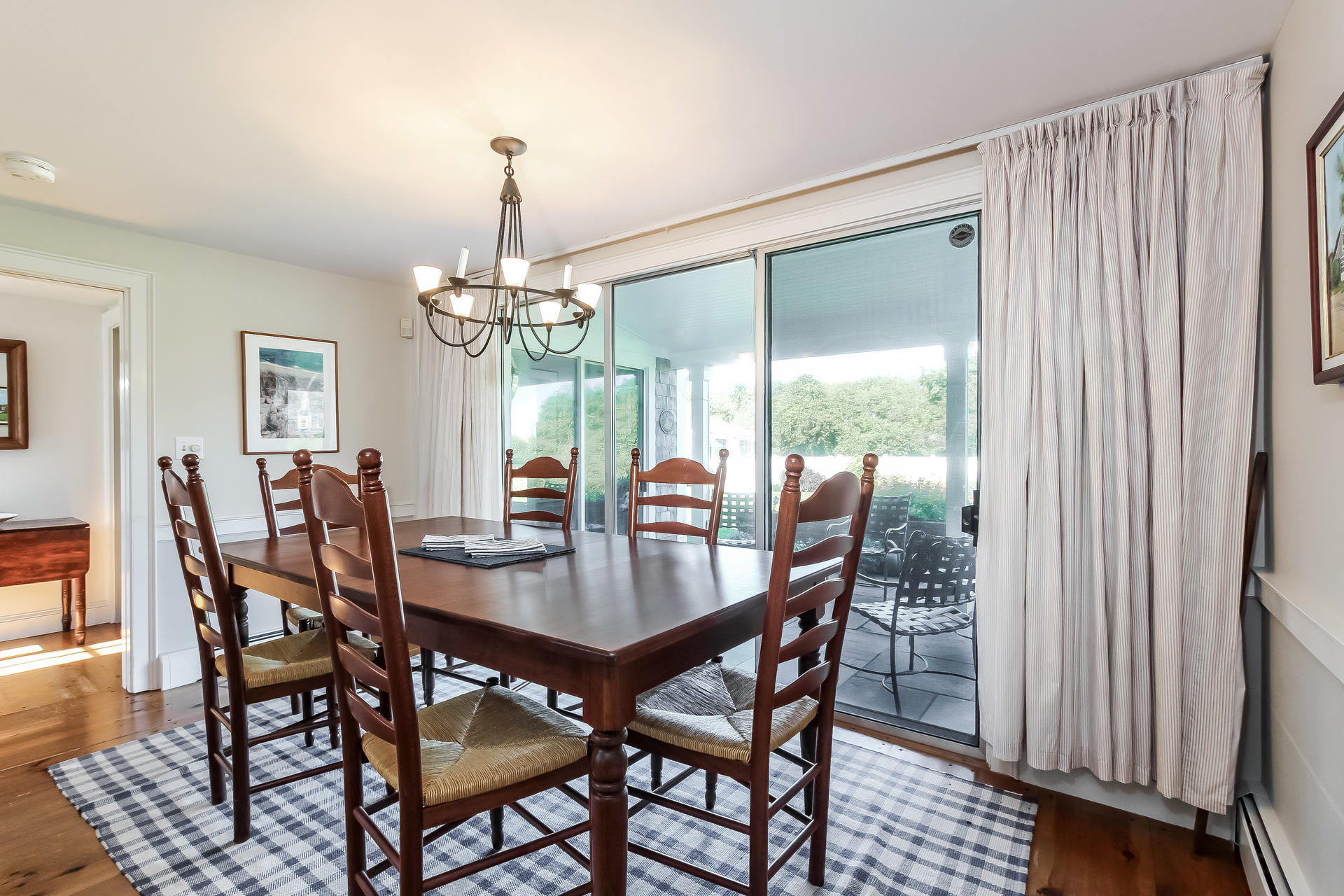 489 Stage Harbor Road Chatham, MA 02633 - Photo 8 of 34 a view of a dining room with furniture window and wooden floor