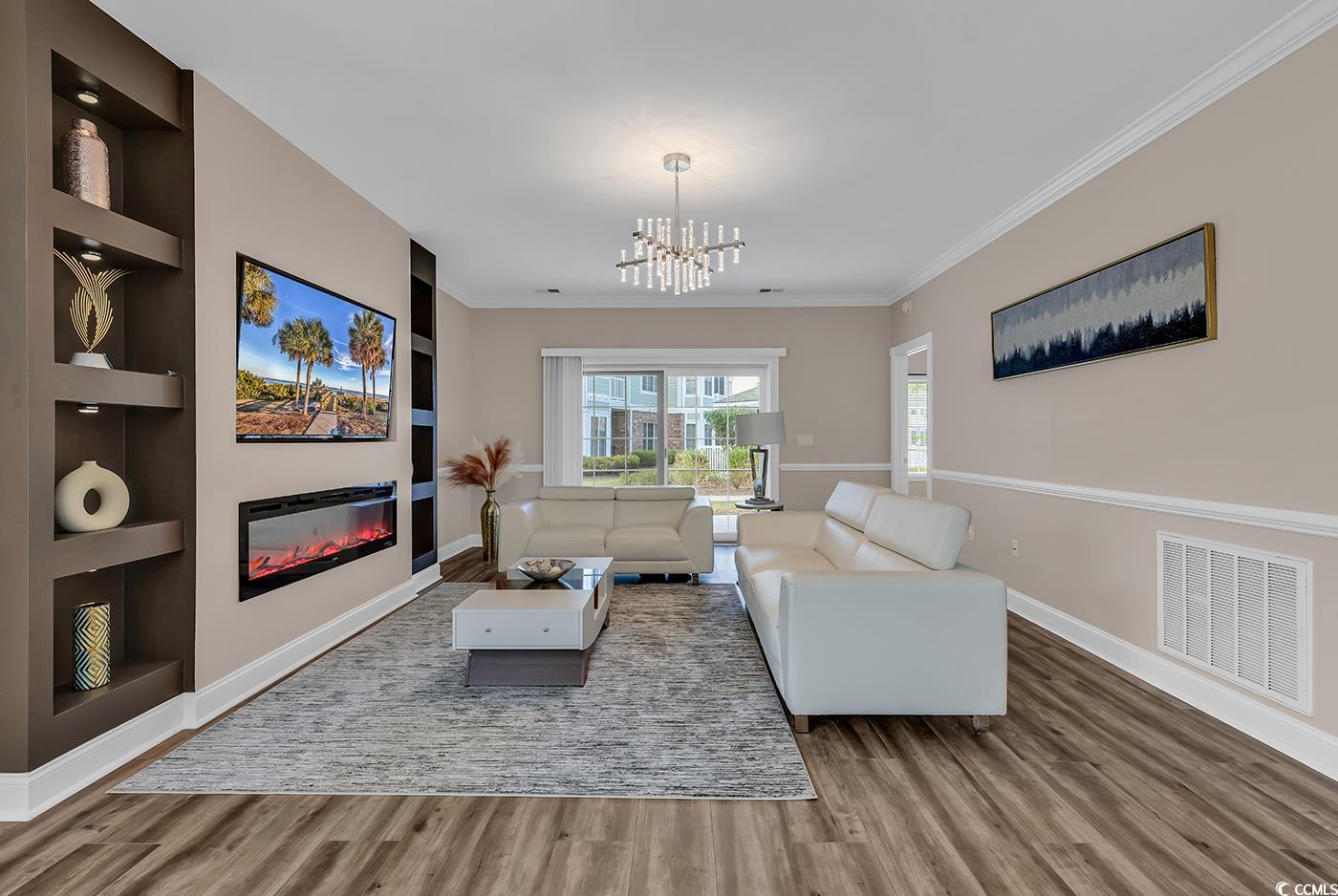 4821 Luster Leaf Circle, Unit 101 Myrtle Beach, SC 29577 - Photo 12 of 40 Living room featuring wood-type flooring, crown mo