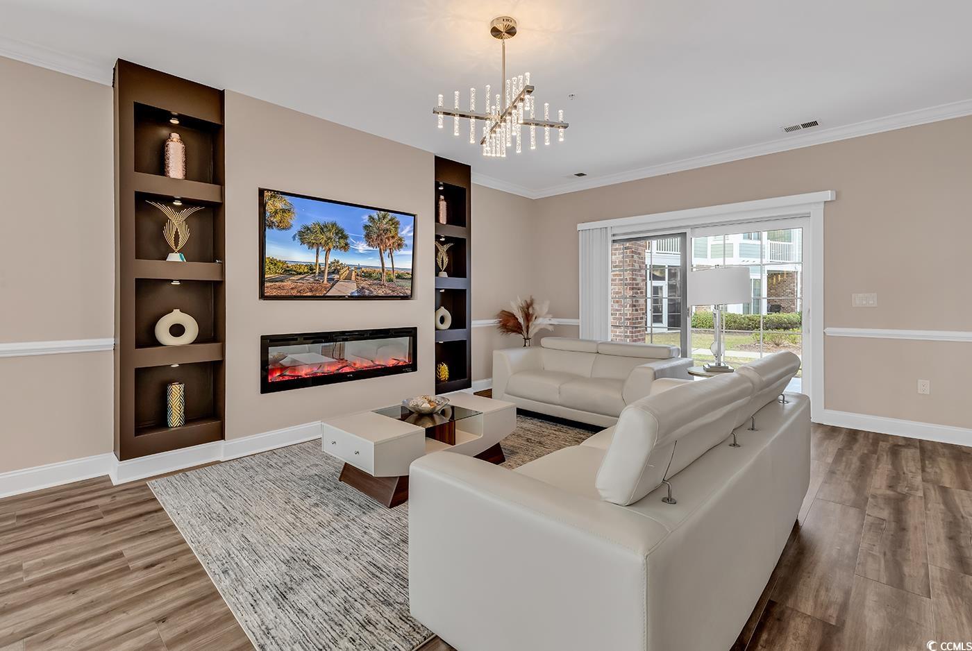 4821 Luster Leaf Circle, Unit 101 Myrtle Beach, SC 29577 - Photo 13 of 40 Living room featuring built in shelves, ornamental