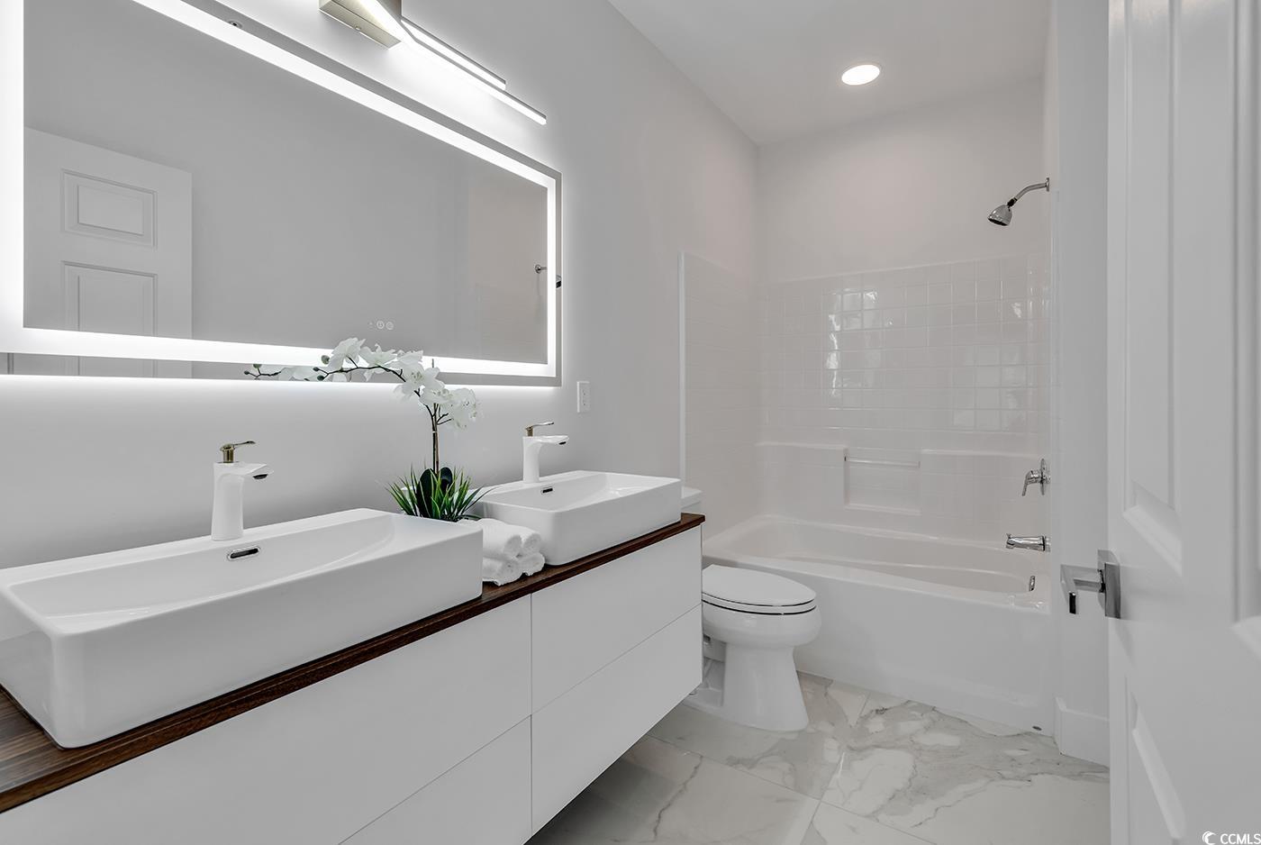 4821 Luster Leaf Circle, Unit 101 Myrtle Beach, SC 29577 - Photo 17 of 40 Full bathroom featuring vanity, toilet, and showe