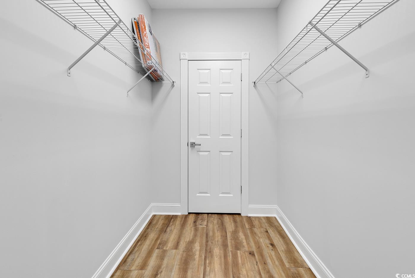 4821 Luster Leaf Circle, Unit 101 Myrtle Beach, SC 29577 - Photo 19 of 40 Spacious closet featuring hardwood / wood-style fl