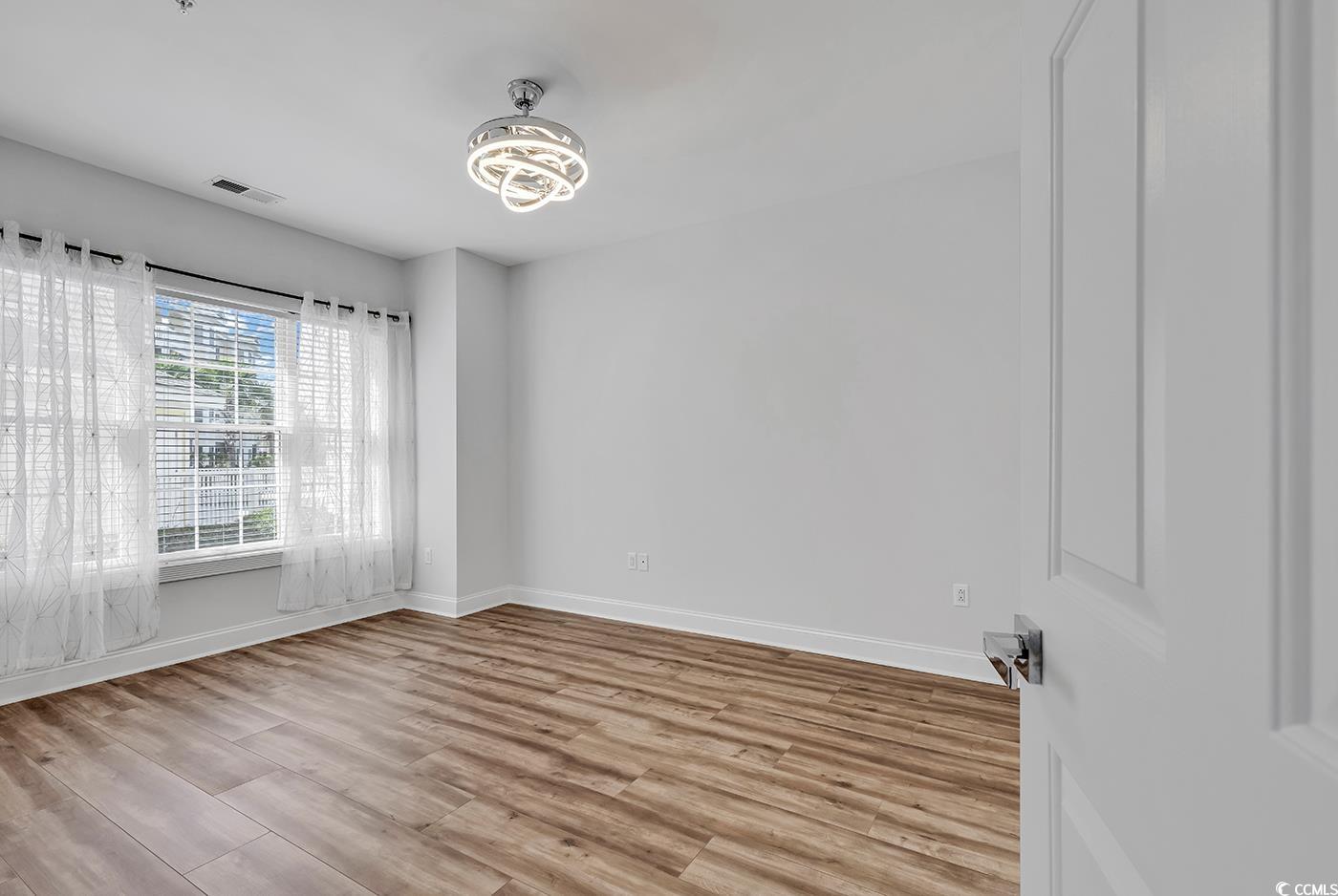 4821 Luster Leaf Circle, Unit 101 Myrtle Beach, SC 29577 - Photo 33 of 40 Empty room featuring light hardwood / wood-style f