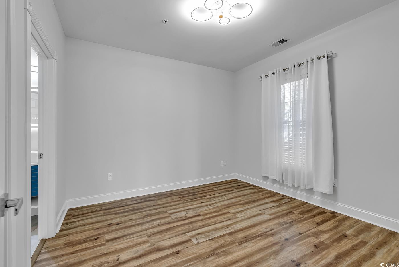 4821 Luster Leaf Circle, Unit 101 Myrtle Beach, SC 29577 - Photo 35 of 40 Unfurnished room featuring light hardwood / wood-s