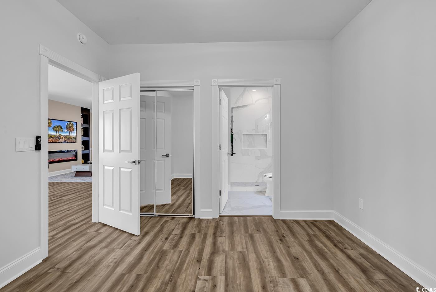 4821 Luster Leaf Circle, Unit 101 Myrtle Beach, SC 29577 - Photo 36 of 40 Unfurnished bedroom with ensuite bath, a closet, a