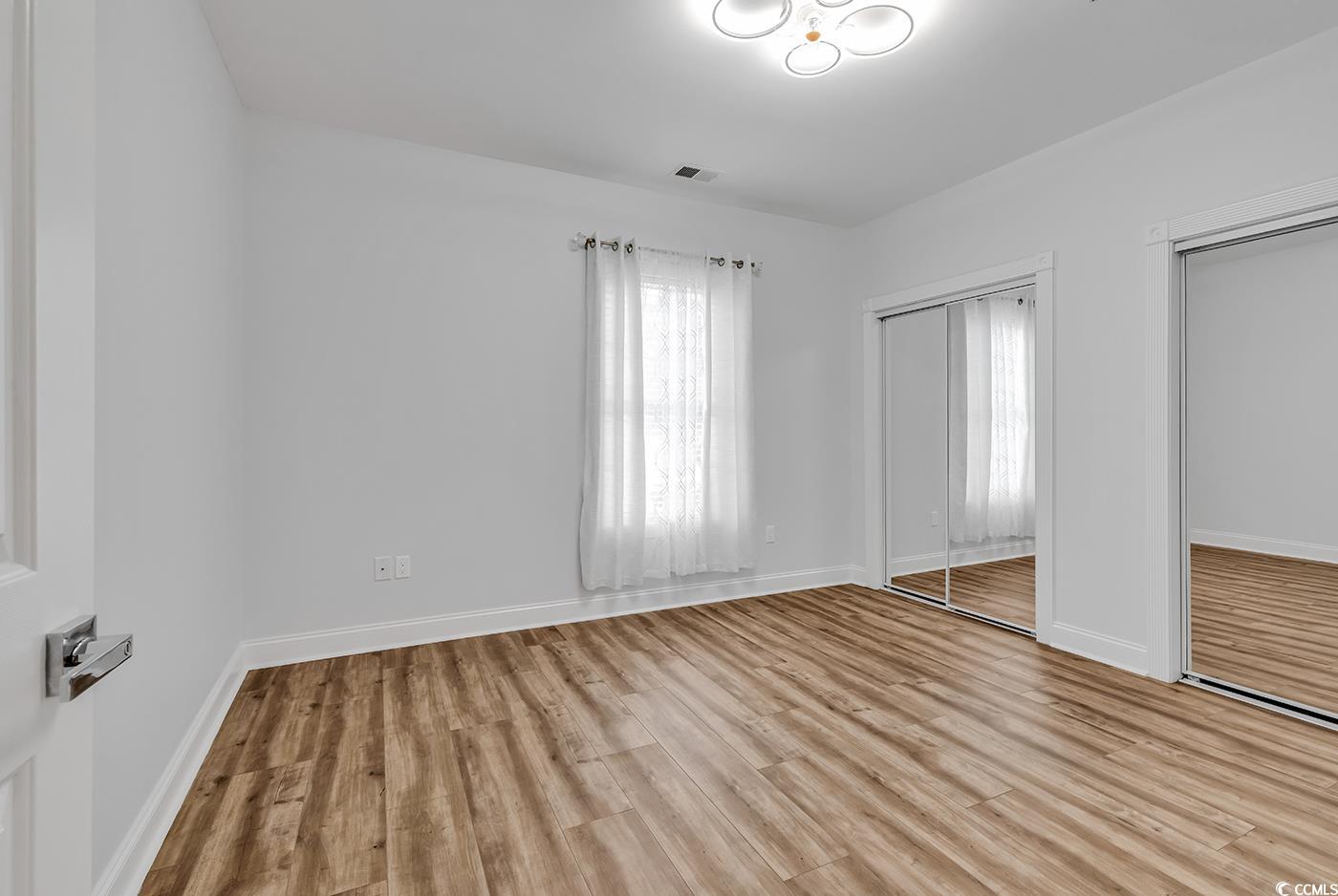 4821 Luster Leaf Circle, Unit 101 Myrtle Beach, SC 29577 - Photo 37 of 40 Unfurnished bedroom featuring light hardwood / woo