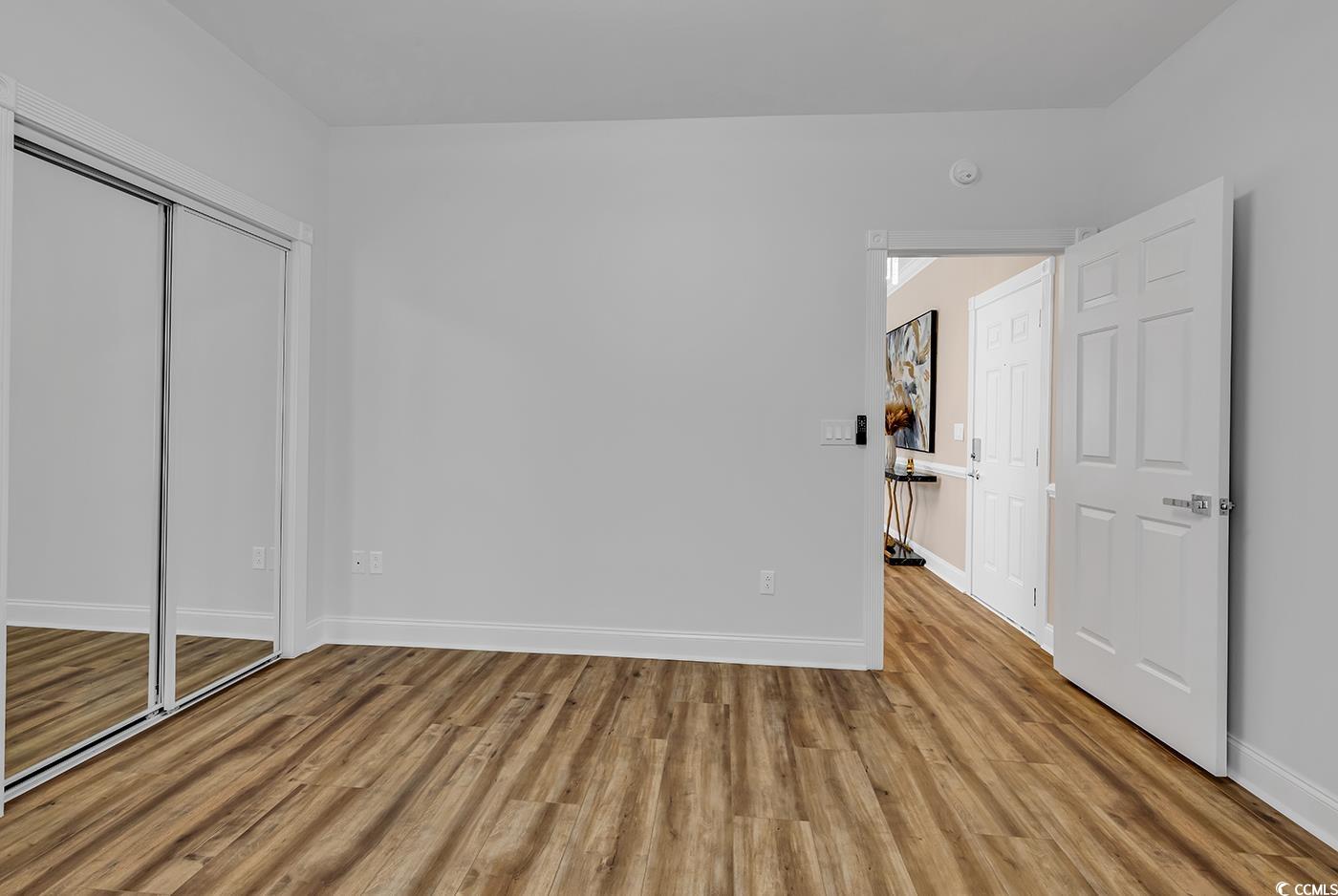 4821 Luster Leaf Circle, Unit 101 Myrtle Beach, SC 29577 - Photo 38 of 40 Unfurnished bedroom with light wood-type flooring