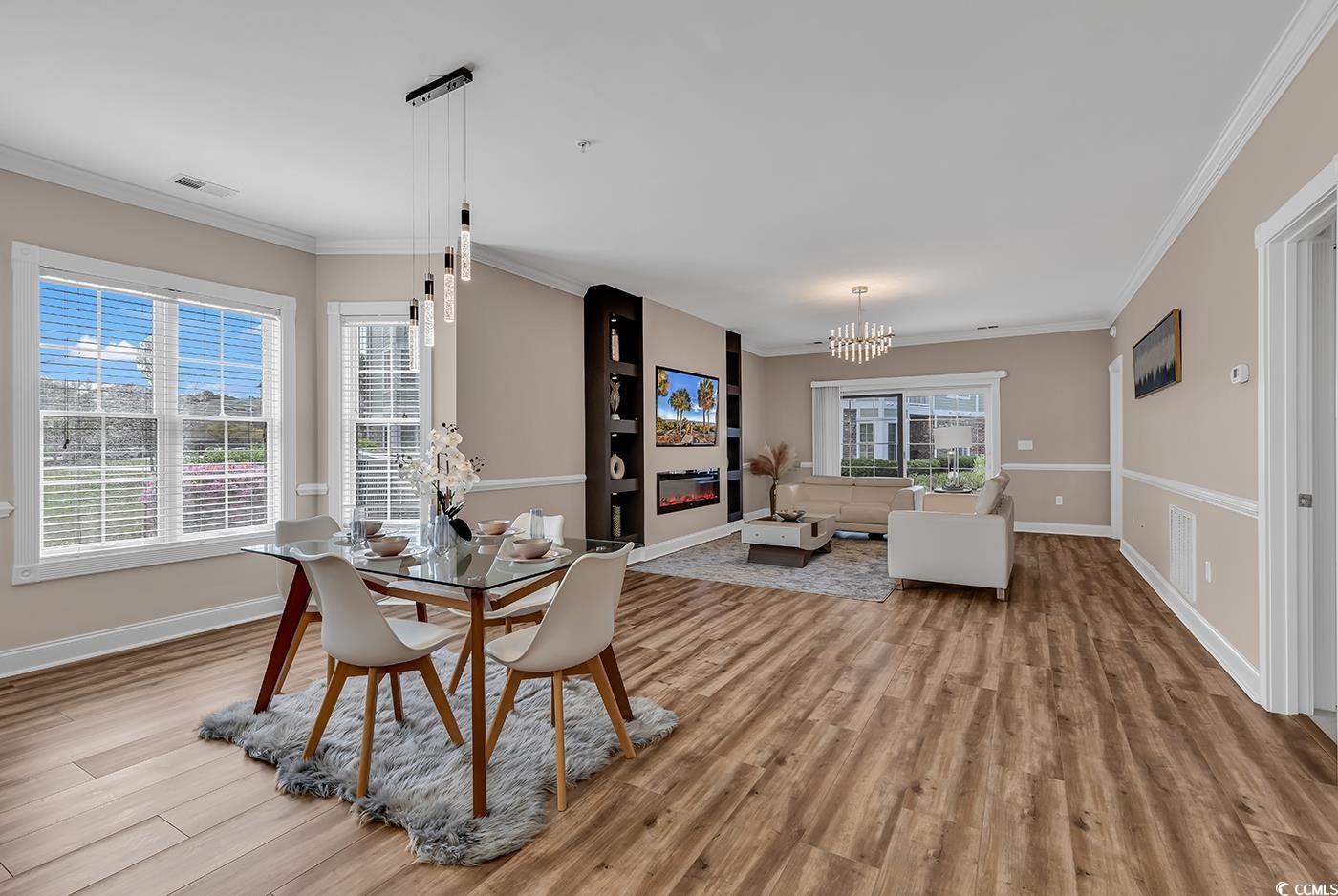 4821 Luster Leaf Circle, Unit 101 Myrtle Beach, SC 29577 - Photo 10 of 40 Dining room with a chandelier, light hardwood / wo