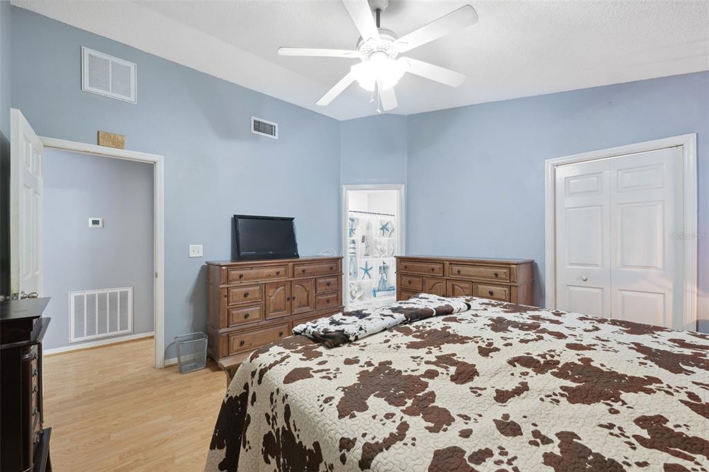 1221 Emerson Street Inverness, FL 34450 - Photo 16 of 39 a bedroom with a large bed and a flat tv screen