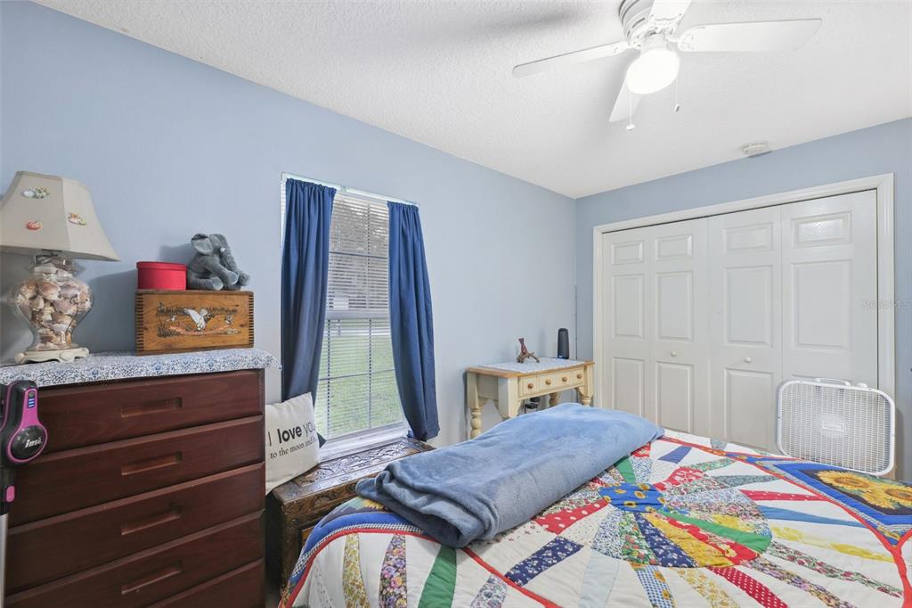 1221 Emerson Street Inverness, FL 34450 - Photo 21 of 39 a bedroom with a bed and wooden floor